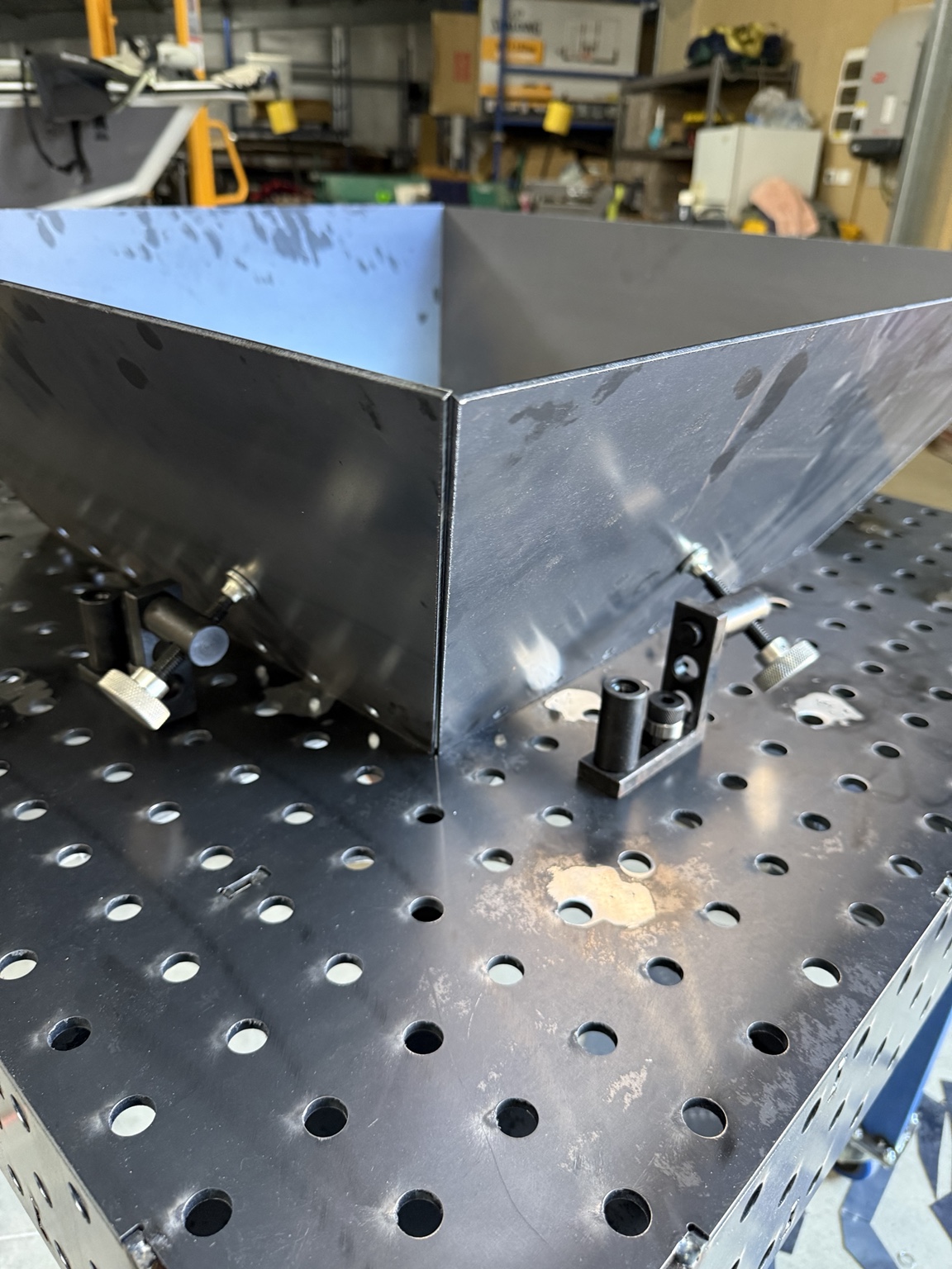 Folded steel tray on a fabrication table